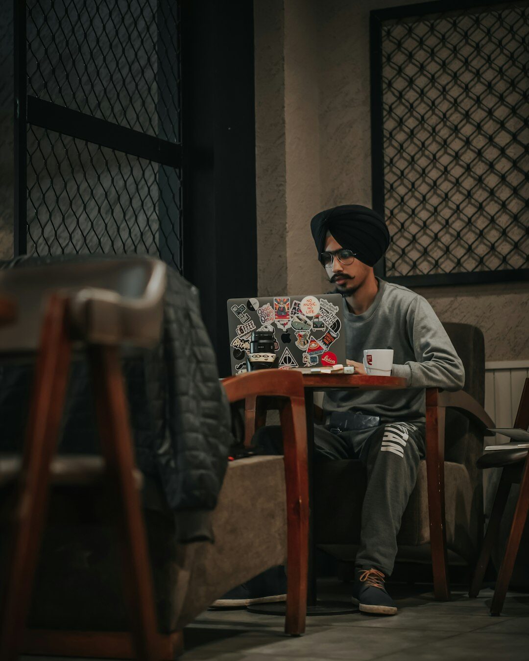 Journalist typing notes on a laptop at a wooden desk